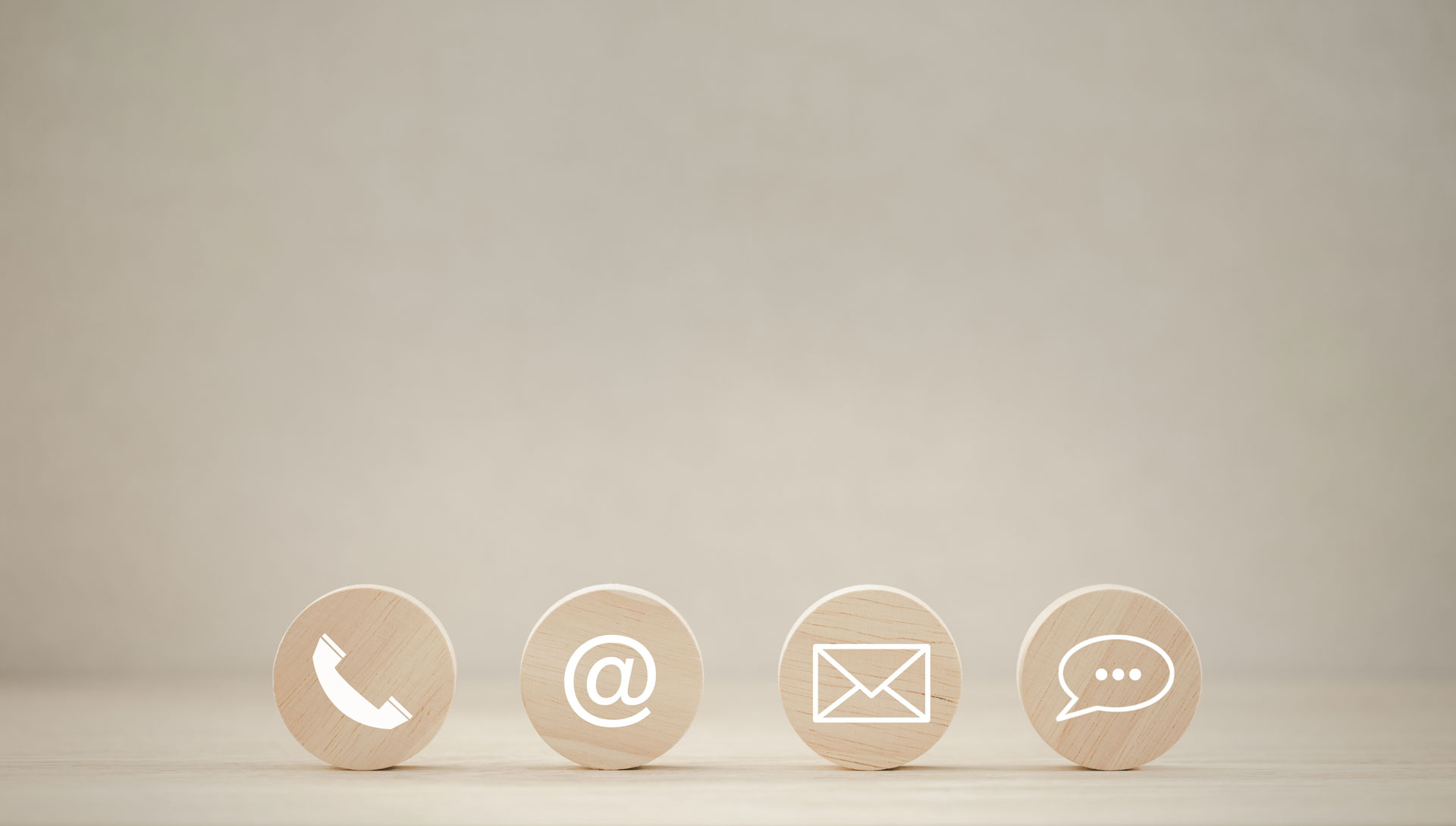 closeup phone, address, mail, chat icon on round wooden piece © Adobe Stock